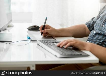 Closeup photo of male designer using graphic tablet