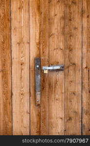 Closeup photo of old door handle on barn wooden door