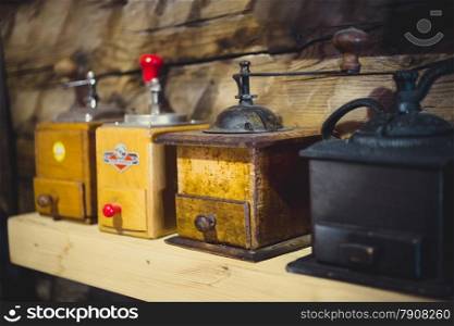 Closeup photo of old manual coffee mills on wooden table
