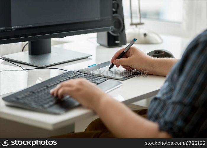 Closeup photo of professional graphic designer at work in office