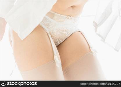 Closeup photo of sexy slim woman in white shirt and lace lingerie