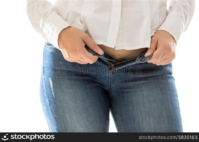 Closeup photo of sexy slim woman putting on blue jeans