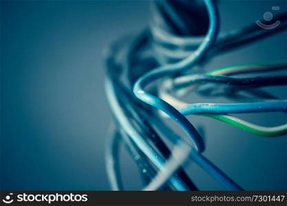 Closeup photo of the cables isolated on blue background, abstract business background, ethernet wires, global communication concept
