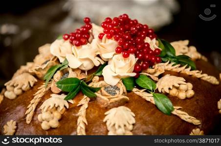 Closeup photo of traditional wedding bread decorated with berries
