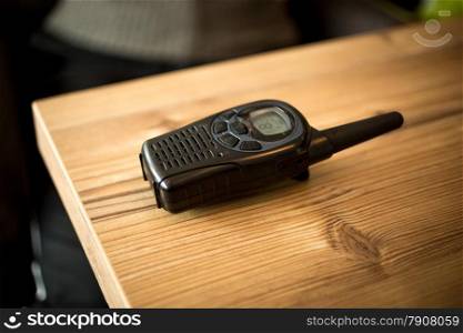 Closeup photo of walkie-talkie lying on wooden table