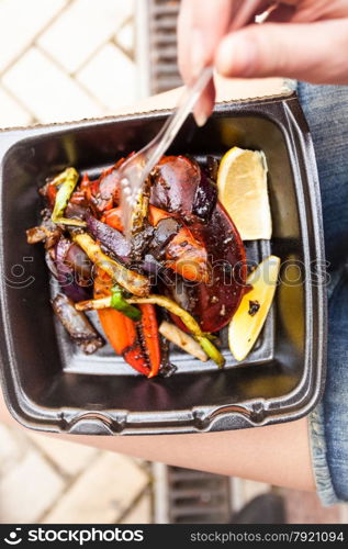 Closeup photo of woman eating lobster claw with fork