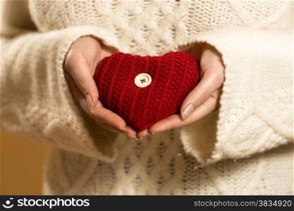 Closeup photo of woman holding red heart in hands