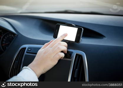 Closeup photo of woman using GPS navigator at car