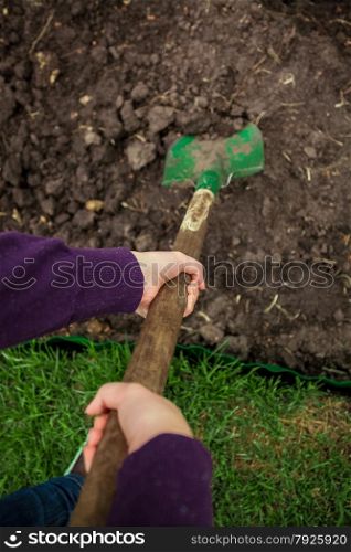 closeup photo of women hands digging soil with shovel