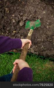 closeup photo of women hands digging soil with shovel