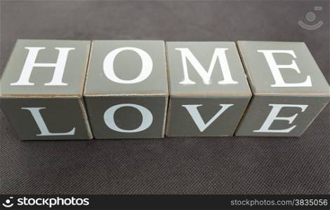 Closeup photo of words love and home written on wooden bricks