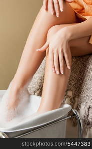 closeup picture of female hands and legs in spa salon