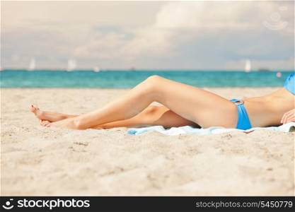 closeup picture of female legs and bikini .