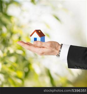 closeup picture of man hands holding eco house
