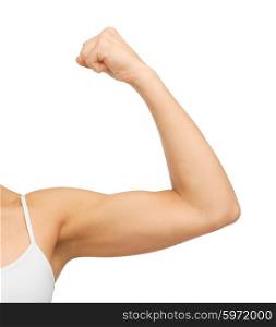 closeup picture of sporty woman flexing her biceps. sporty woman flexing her biceps