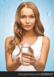 closeup picture of woman hands holding glass of water .