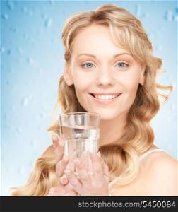 closeup picture of woman hands holding glass of water .