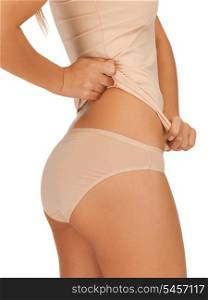 closeup picture of woman in beige cotton undrewear showing slimming concept