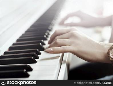 Closeup picture of woman playing piano