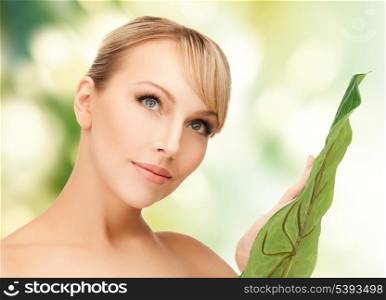 closeup picture of woman with green leaf