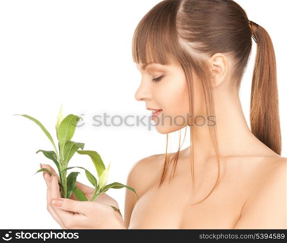 closeup picture of woman with green sprout.
