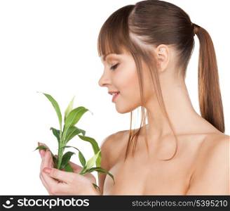 closeup picture of woman with green sprout.
