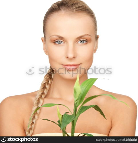 closeup picture of woman with green sprout