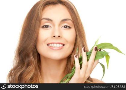 closeup picture of woman with green sprout