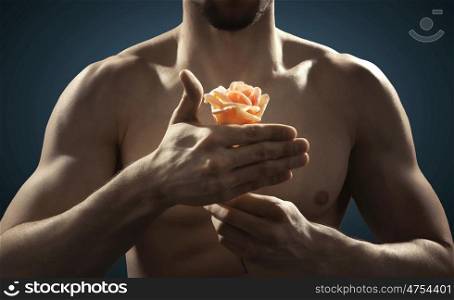 Closeup picture of young athlete holding a flower