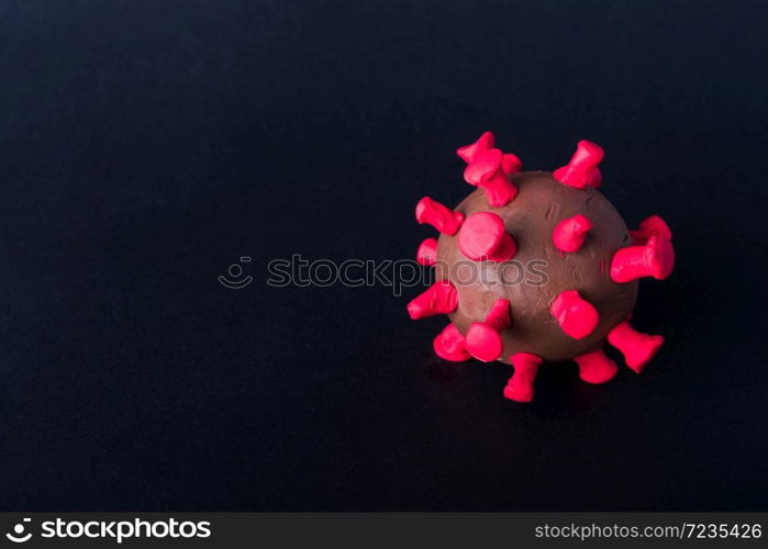 Closeup plasticine disease cells virus of coronavirus outbreak and coronaviruses influenza flu, studio shot isolated on black background, pandemic COVID-19 medical health risk concept