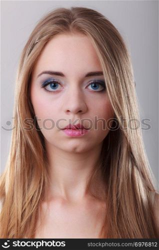 Closeup portrait attractive pensive woman, blonde blue eyes long hair girl on gray