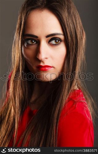 Closeup portrait beautiful young woman long straight hair dark makeup red lips on gray