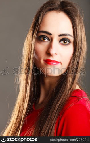 Closeup portrait beautiful young woman long straight hair dark makeup red lips on gray