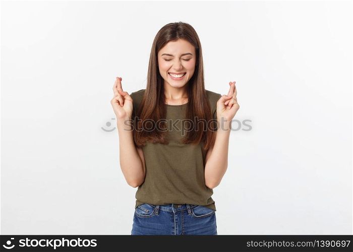 Closeup portrait hopeful beautiful woman crossing her fingers, open eyes, hoping, asking best isolated on gray wall background. Closeup portrait hopeful beautiful woman crossing her fingers, open eyes, hoping, asking best isolated on gray wall background.