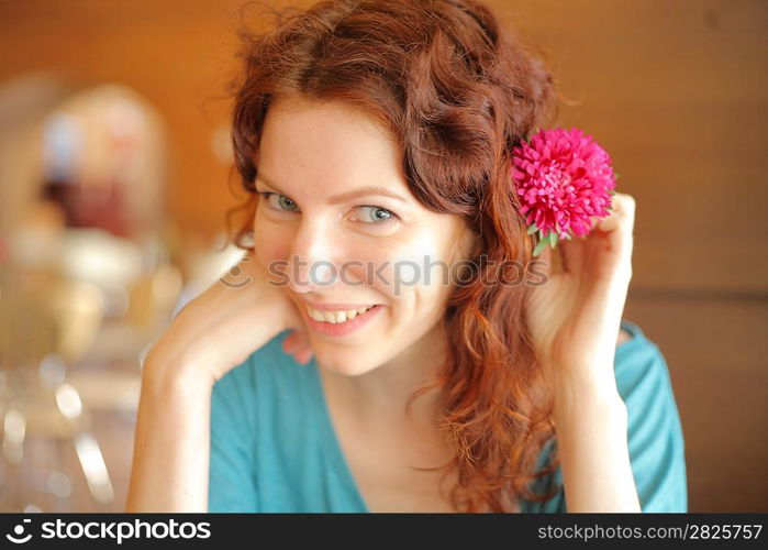 Closeup portrait of a attractive girl with flower in her hair