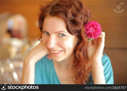 Closeup portrait of a attractive girl with flower in her hair