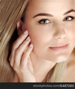 Closeup portrait of a beautiful blond woman with perfect skin, cute young female applying anti dryness and anti aging cream, using natural cosmetics, health and beauty care concept. Beautiful woman portrait