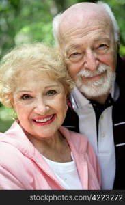 Closeup portrait of a beautiful, happy senior couple. Focus on her eyes.