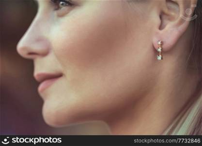 Closeup Portrait of a Beautiful Young Woman Wearing Gorgeous Stylish Earring. Profile Portrait. Luxury Fashionable Jewelry.. Beautiful Woman Wearing Gorgeous Earring
