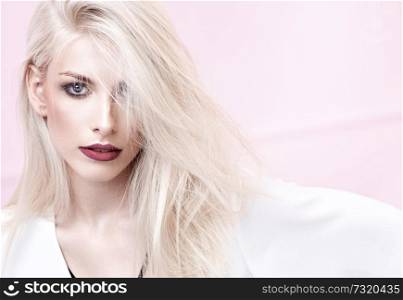 Closeup portrait of a blond young model witg deep red lips