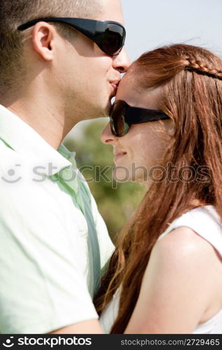 Closeup Portrait Of A Cute Couple Hugging, the men kiss the women