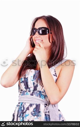 Closeup portrait of a cute young girl talking on mobile phone against white background