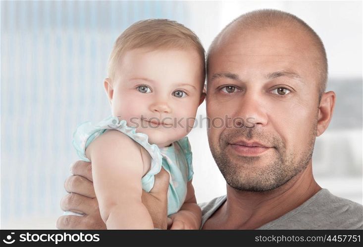 Closeup portrait of a handsome dad with cute little daughter on hands, spending time at home, happy fathers day theme&#xA;