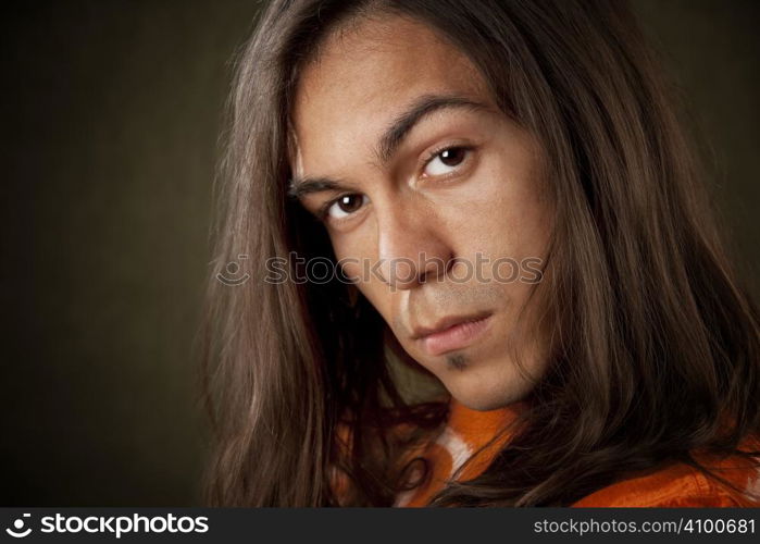 Closeup Portrait of a Handsome Young Man with Long Hair