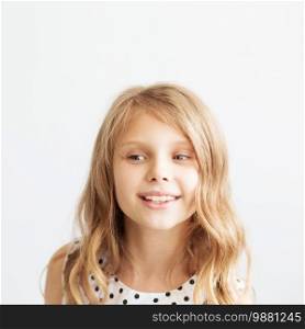 Closeup portrait of a lovely little girl against a white background