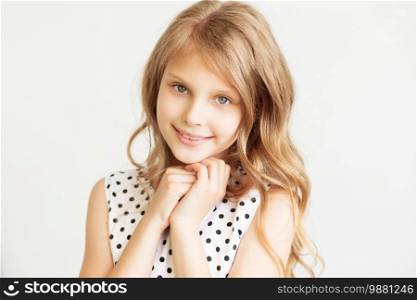 Closeup portrait of a lovely little girl against a white background