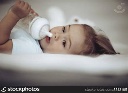 Closeup Portrait of a Sweet Little Child with Pleasure Drinking Formula Before Nap. Happy Healthy Childhood.. Healthy Child Eating