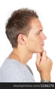 Closeup portrait of a thoughtful young man with hand on his chin