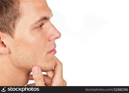 Closeup portrait of a thoughtful young man with hand on his chin