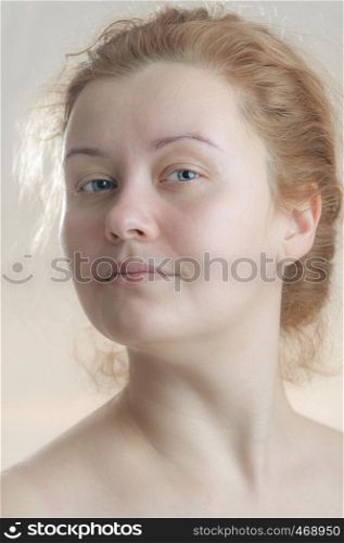 Closeup portrait of a young adult attractive woman with red hair without makeup. Art toning. Soft focus. Neutral background.. Closeup portrait of a young adult attractive woman with red hair without makeup. Art toning.